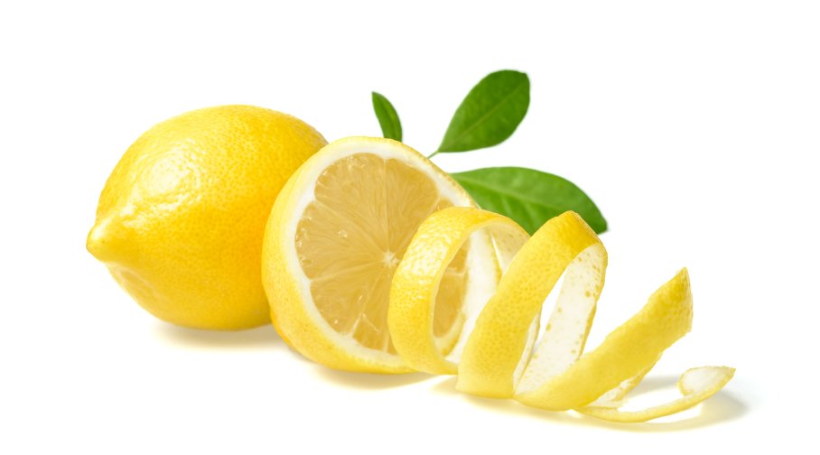 Fresh lemon peels on a white surface